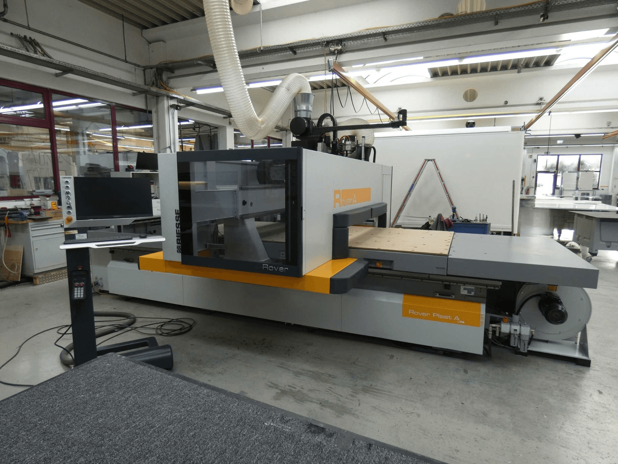 BIESSE ROVER PLAST A FT 1224 -CNC-puunkäsittelykeskuksen etunäkymä, jossa näkyvät näyttö ja ohjauspaneeli.
