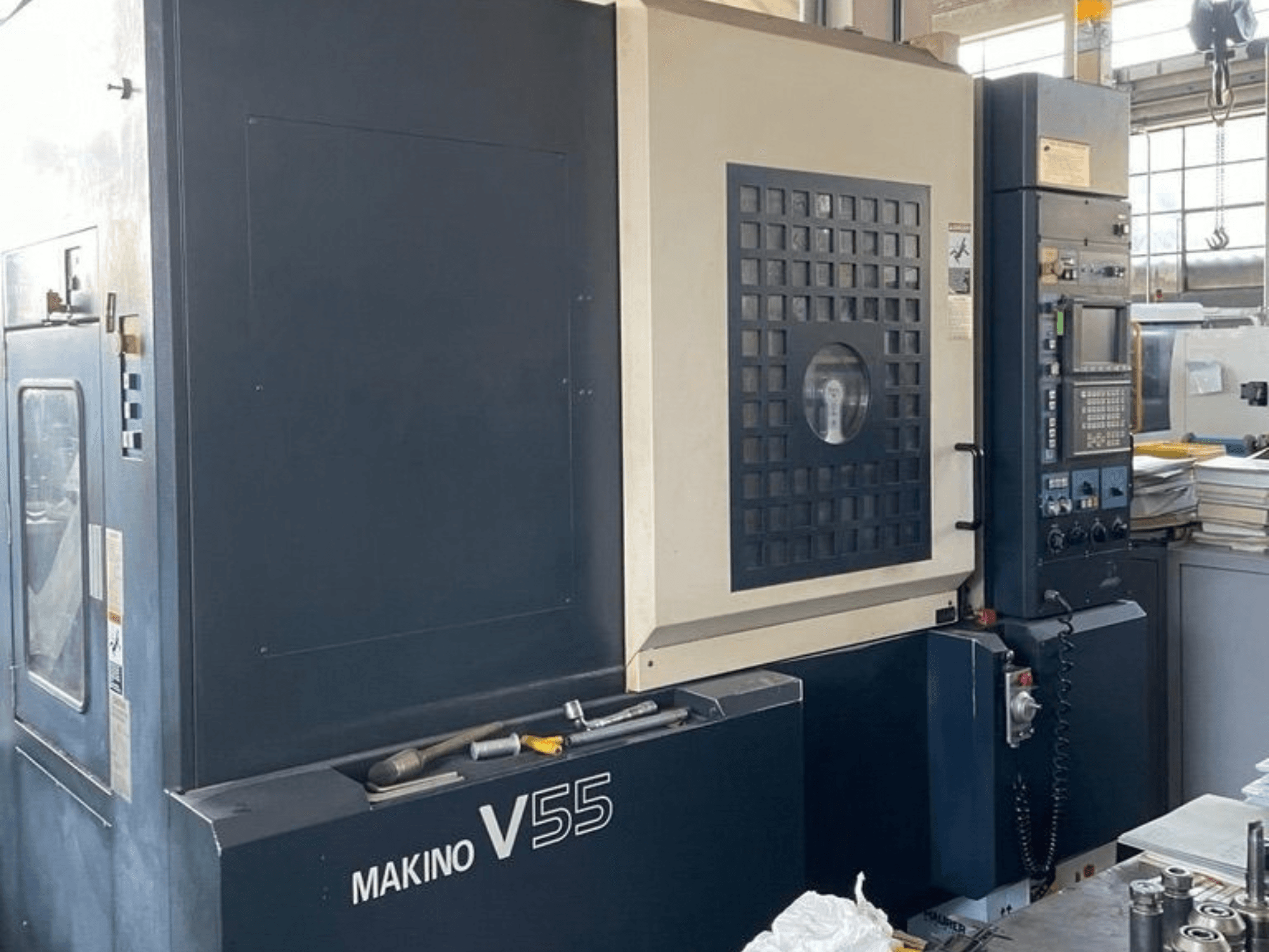 Makino V55-A15 -pystykoneistuskeskus, etunäkymä, jossa näkyy ohjauspaneeli, vankka rakenne ja työtilan järjestely.