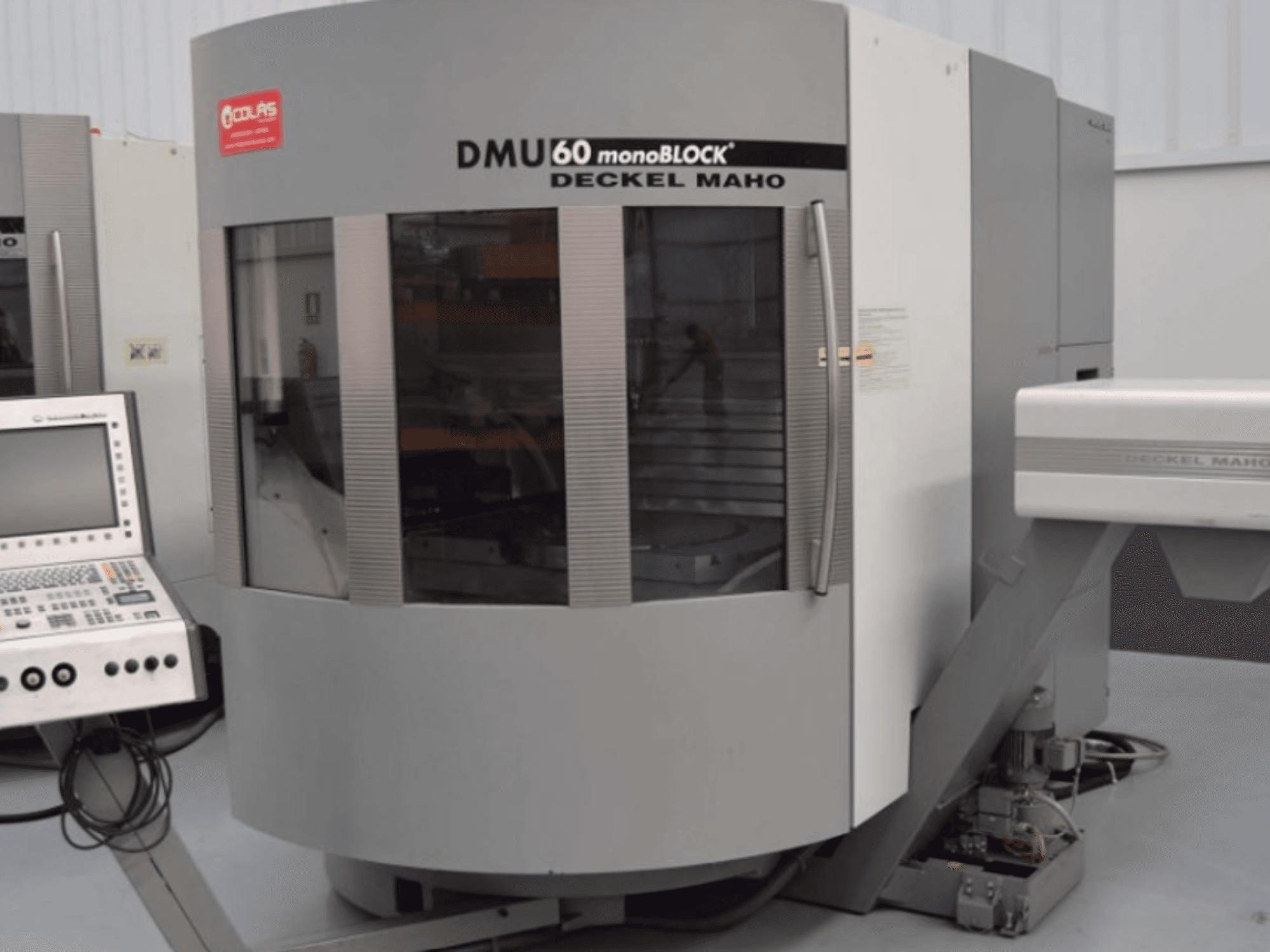 DMG DMU60 Monoblock -pystykoneistuskeskus, kuvattu edestä, ohjauspaneeli näkyvissä vasemmalla.