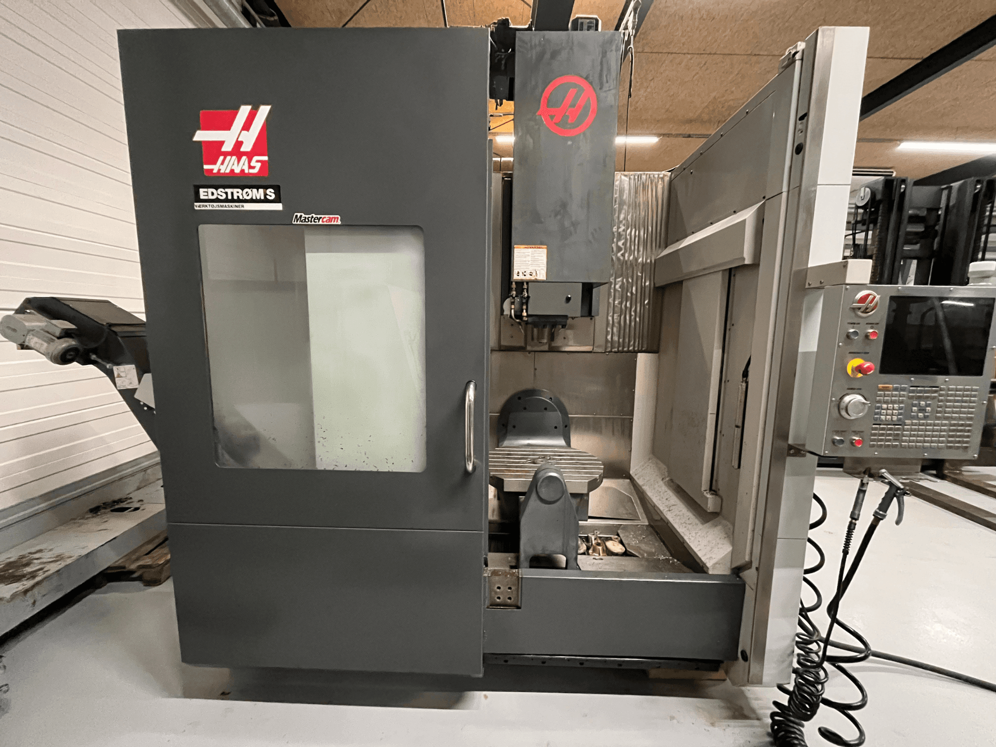 Haas EDSTROM S CNC-koneen etukuva, jossa näkyy ohjauspaneeli, karan pää ja työstöpöytä.