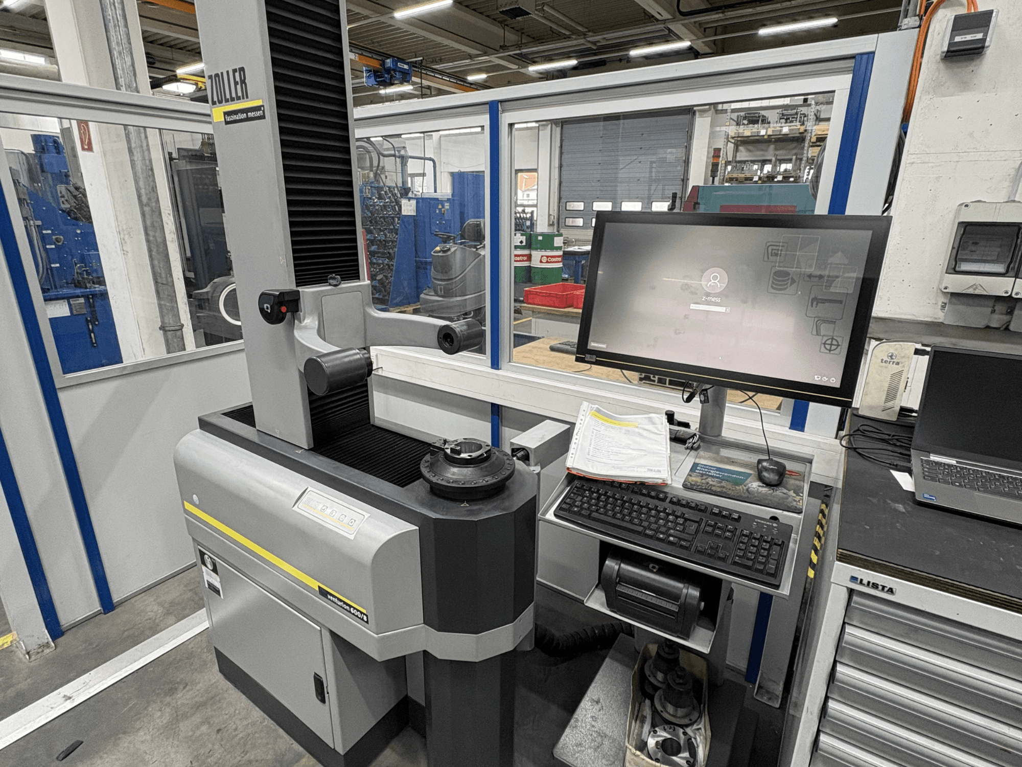 Zoller Venturion 600/8 -optinen mittauskone työpajassa, jossa on näyttö, näppäimistö ja mittausalusta sivukuvassa.
