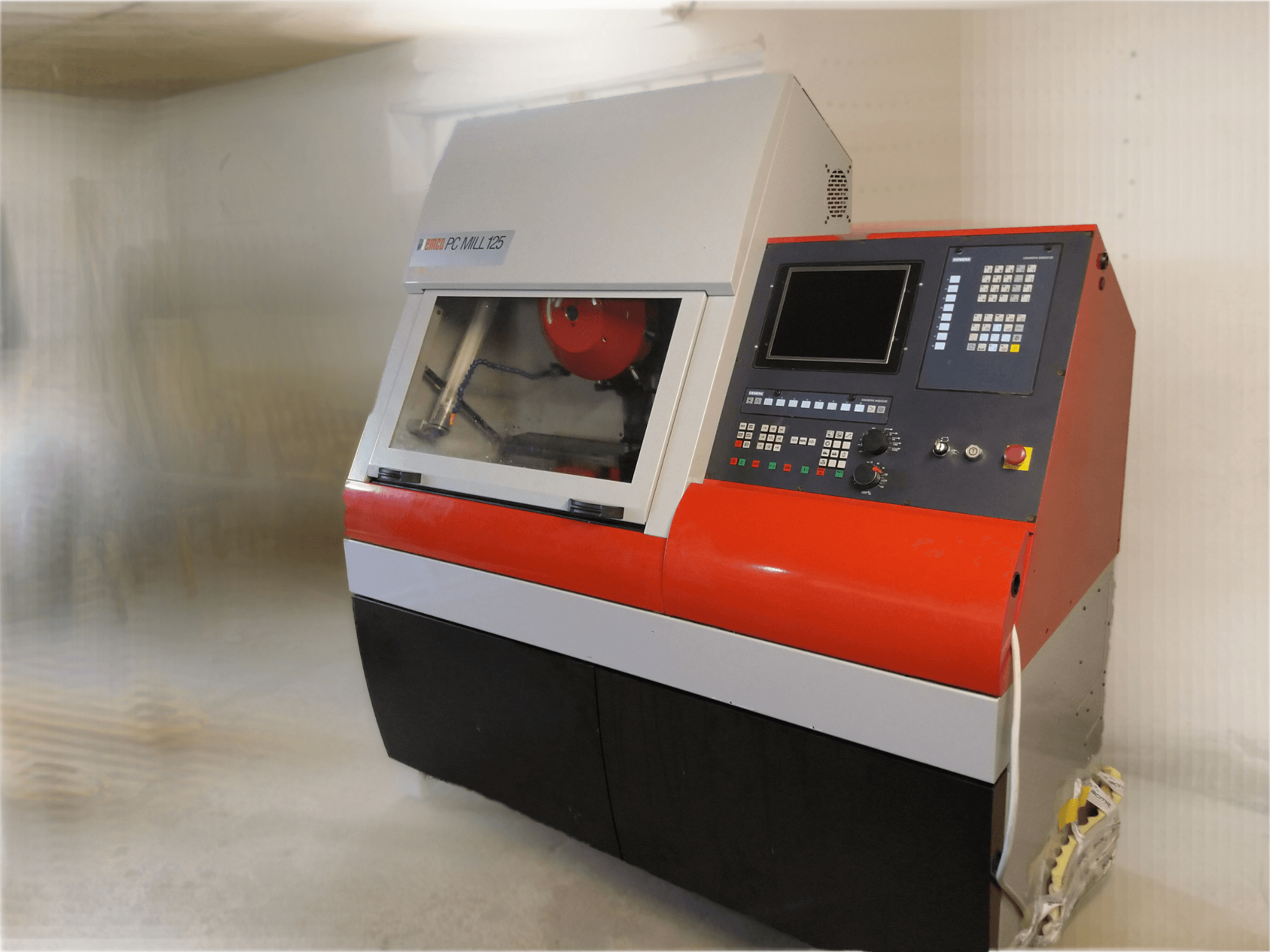 EMCO PC MILL 125 -pystytyöstökeskus, etukuva, jossa ohjauspaneeli ja näkyvissä oleva työstöalue.