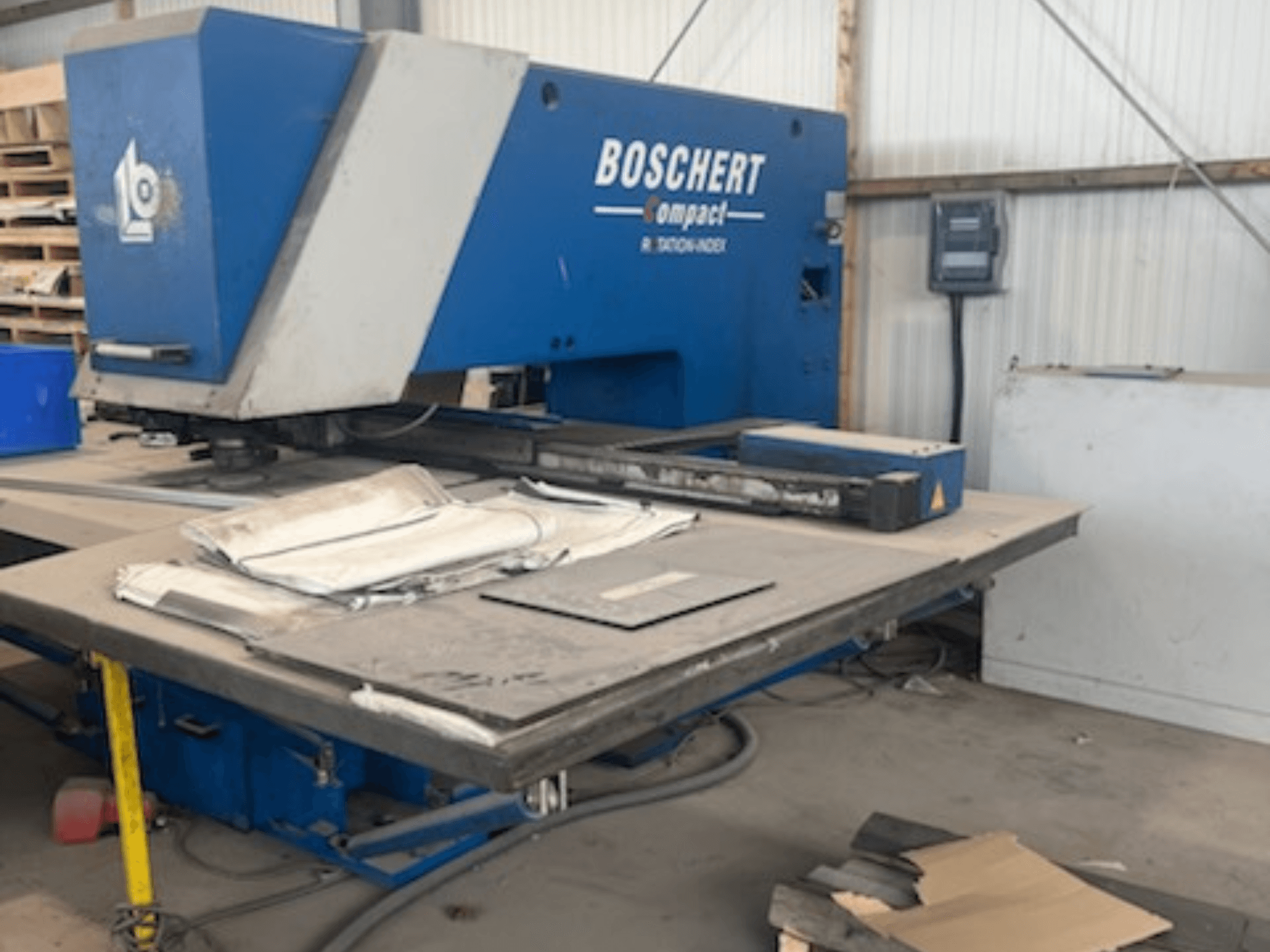 BOSCHERT COMPACT 1000 CNC-lävistyskone työpajassa; kuvassa etunäkymä, jossa pöydällä on metallilevyjä.