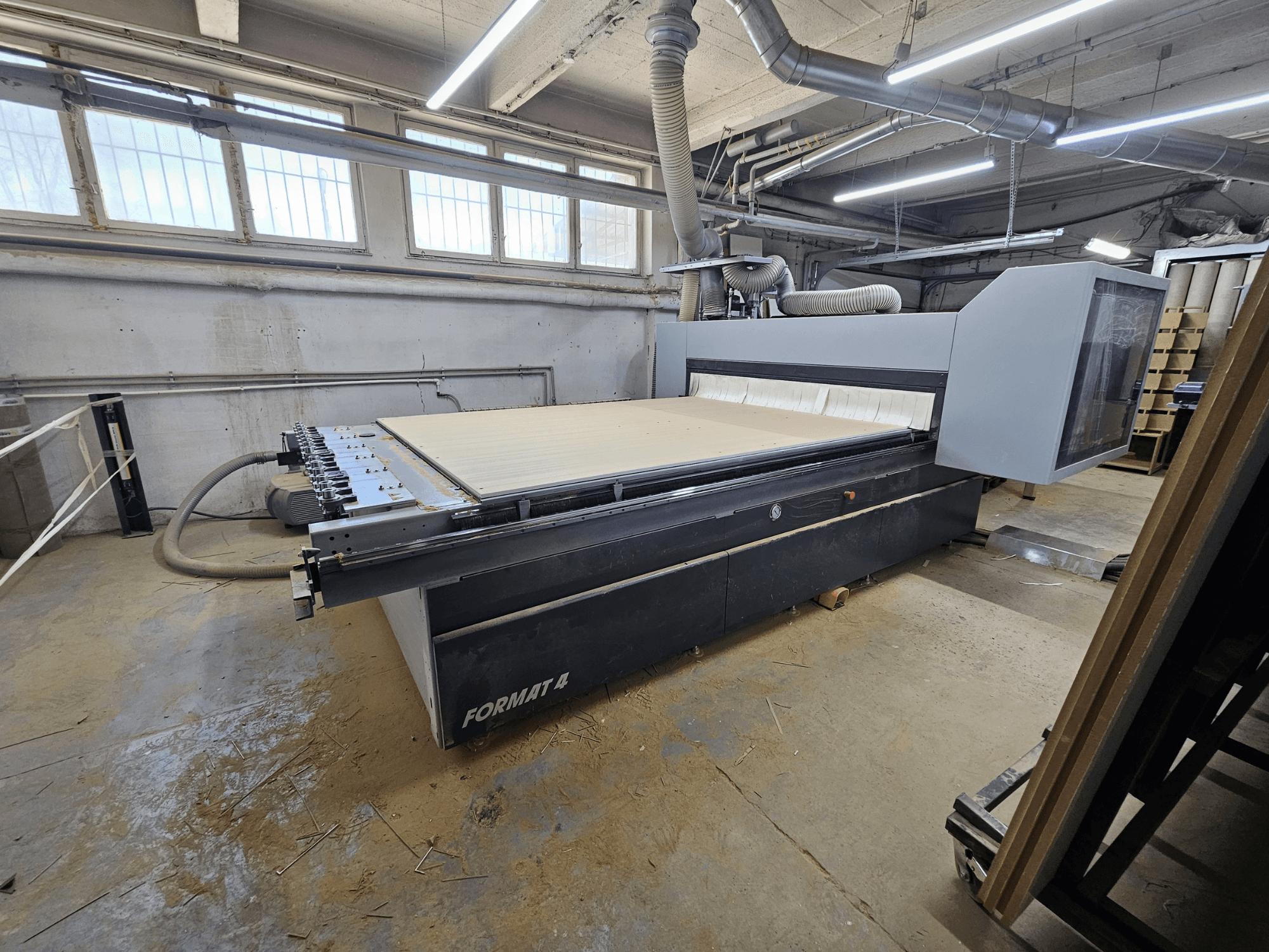 CNC-jyrsin FORMAT4 Profit H80 21.31, sivukuva, jossa näkyy suuri työpöytä ja ohjauspaneeli työpajassa.