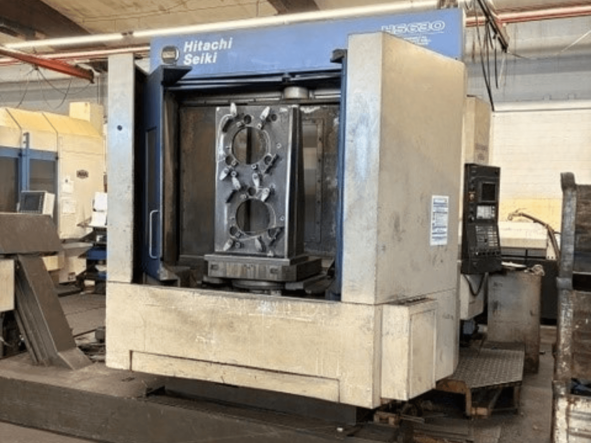 Hitachi Seiki HS630 -vaakakoneistuskeskus, etunäkymä, jossa näkyy työkappale ja ohjauspaneeli.