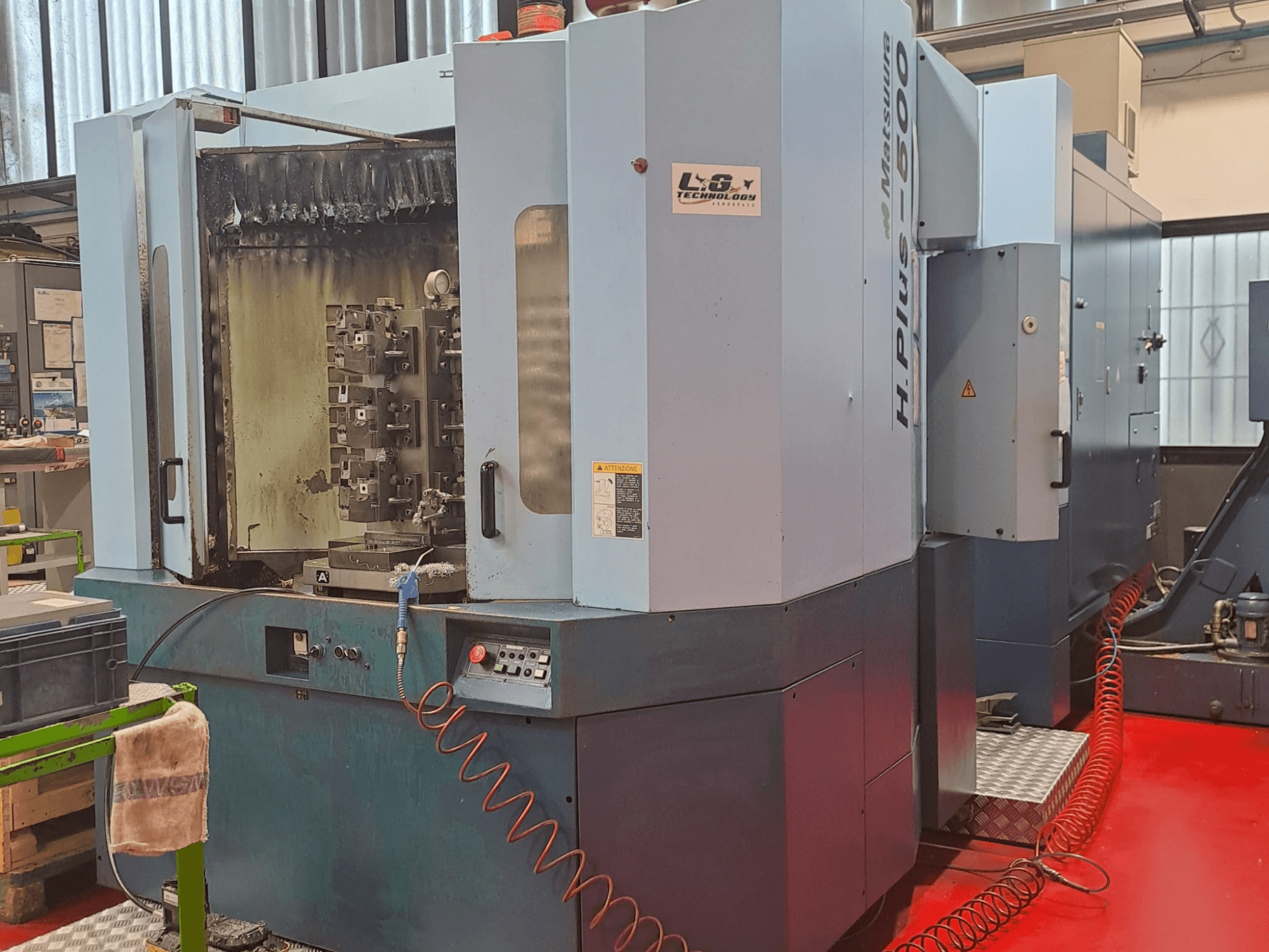 Matsuura H.PLUS-500 -vaakakoneistuskeskus, sivukuva, jossa näkyy hallintalaitteet ja kara, jossa on näkyviä kulumisjälkiä.