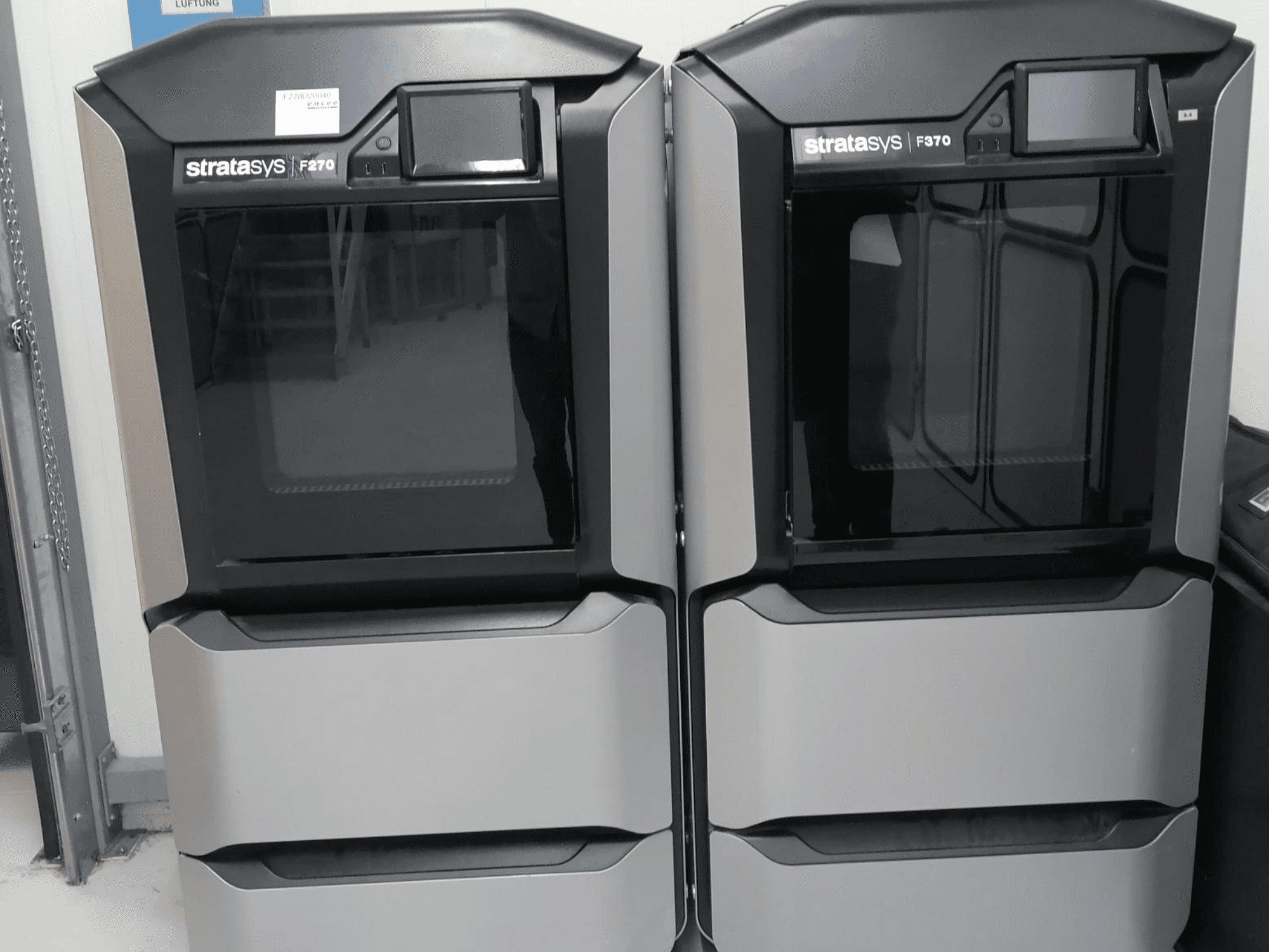 Stratasys F370 dual plastic 3D-tulostin etukuvassa, jossa on tyylikäs musta ja hopeinen muotoilu ja ohjausnäytöt.