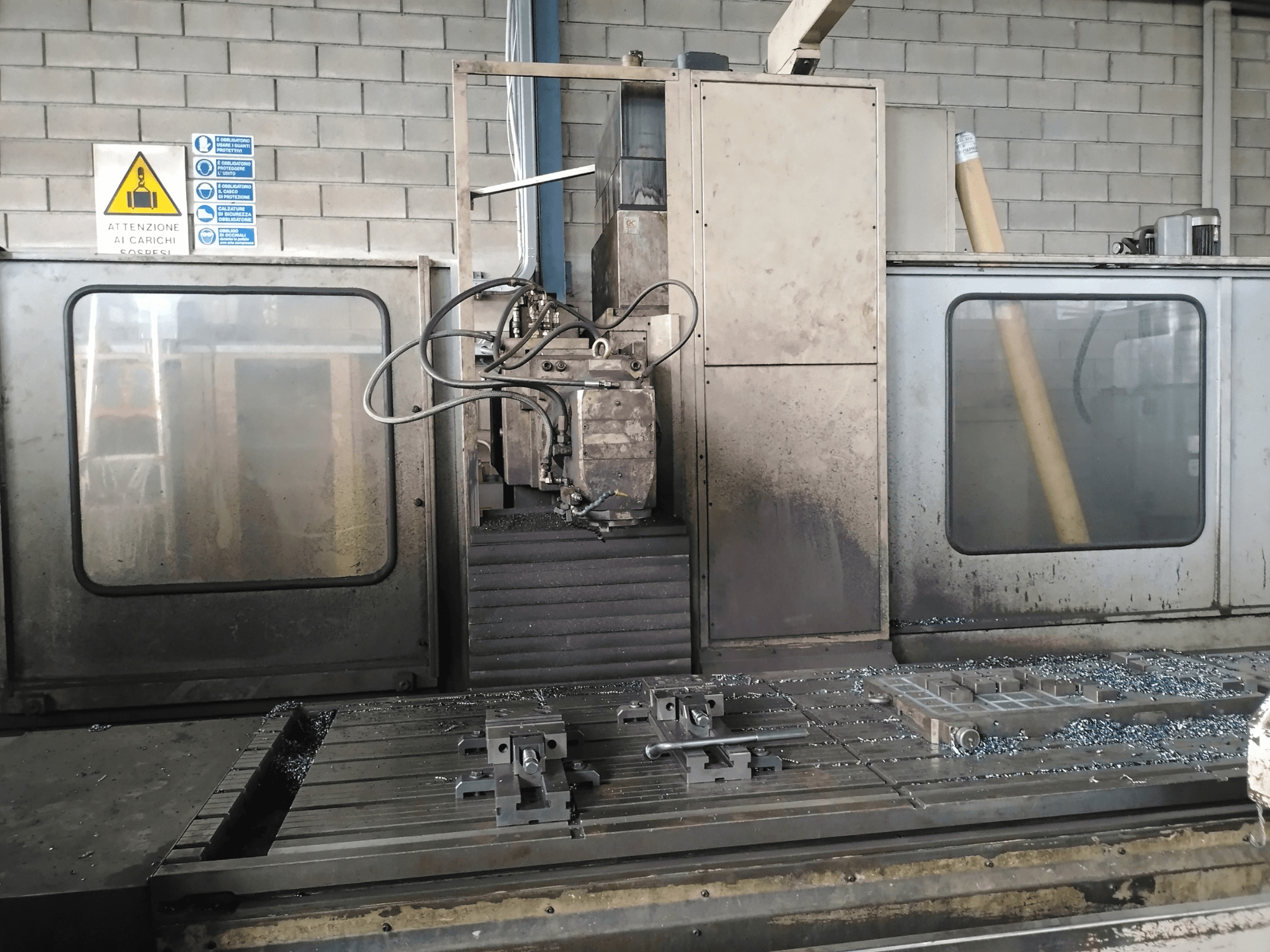 TIGER TFA6 sängyn tyyppinen jyrsinkone työpajassa, etukuva, jossa näkyy työkaluja ja metallilastuja pöydällä.